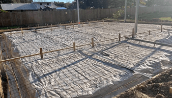 construction staking survey layout with stakes and markers guiding excavation and foundation placement on a jobsite